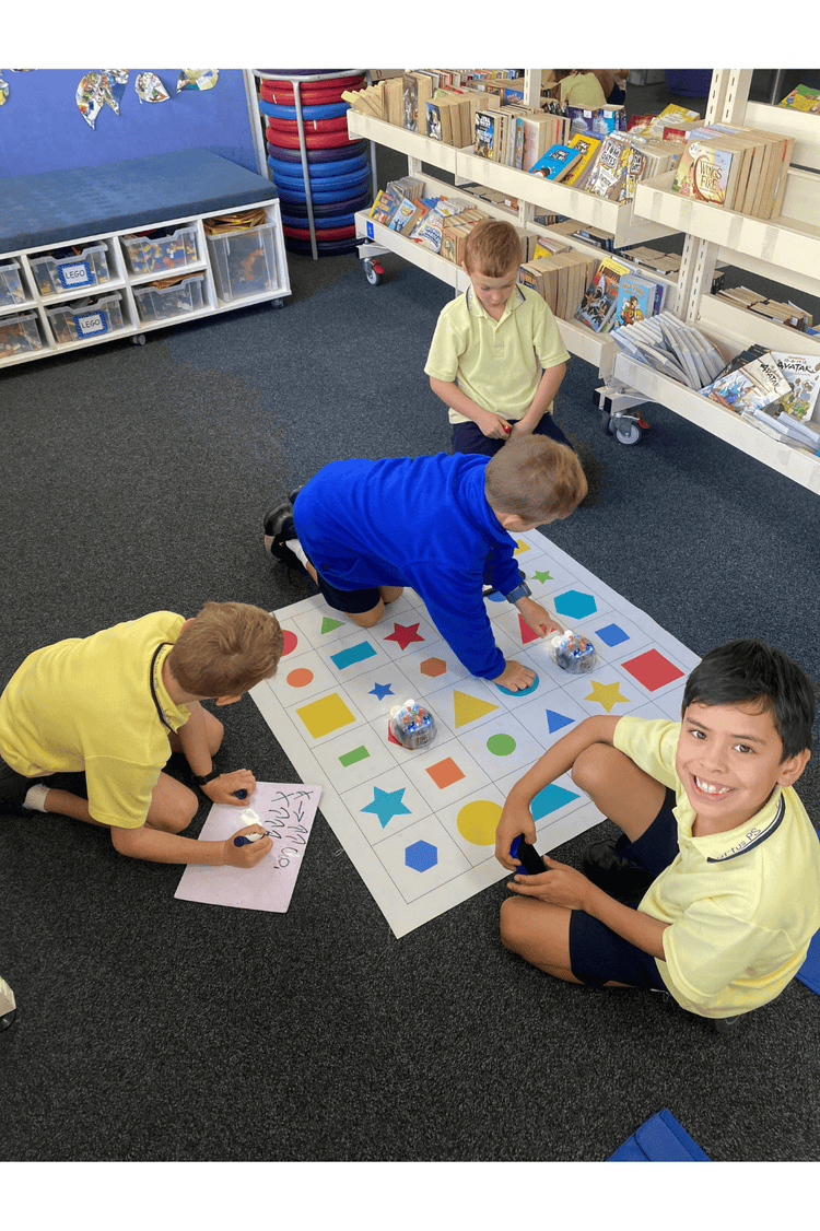 photo of students programming Blubots